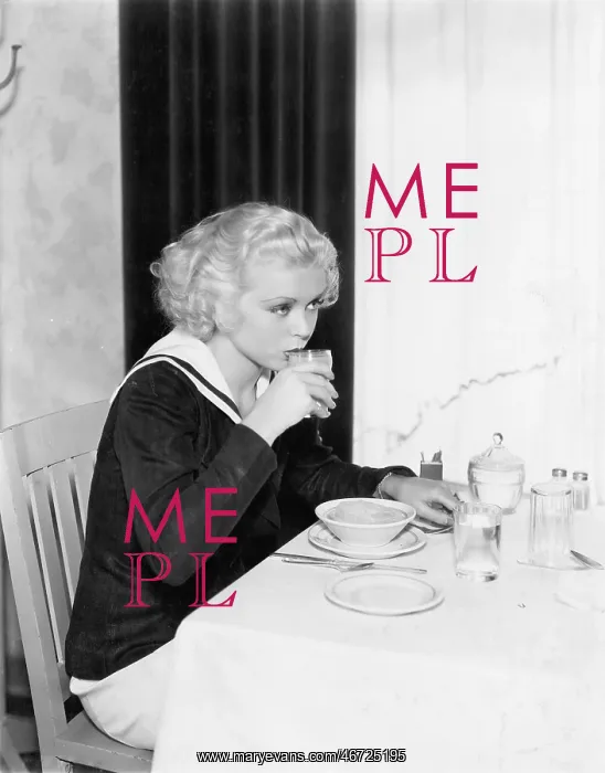  : Young woman having breakfast in a restaurant