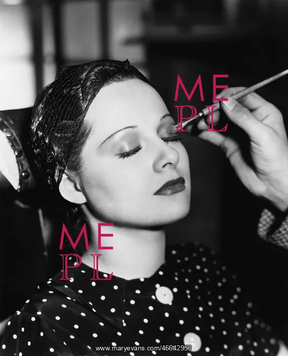 : Young woman having make up done : Young woman having make up done