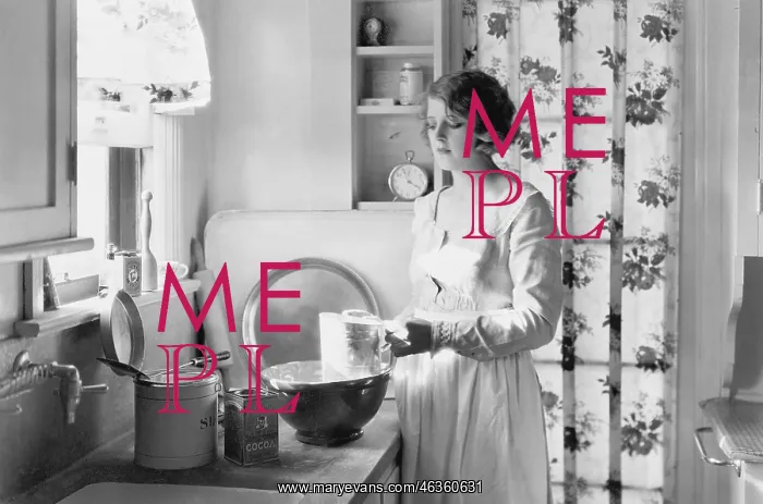 : Young woman in her kitchen, baking : Young woman in her kitchen, baking