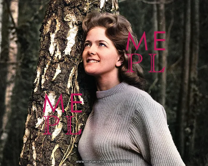  : Young woman leaning against a tree