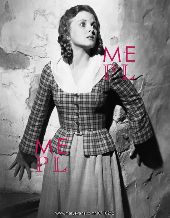 : Young woman leaning against a wall and looking scared : Young woman leaning against a wall and looking scared