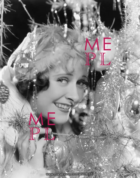 : Young woman looking through the branches of a Christmas : Young woman looking through the branches of a Christmas