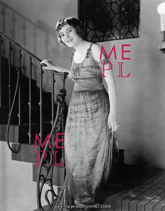 : Young woman moving down a staircase and smiling : Young woman moving down a staircase and smiling