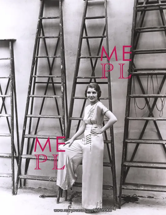 : Young woman posing in front of ladders : Young woman posing in front of ladders