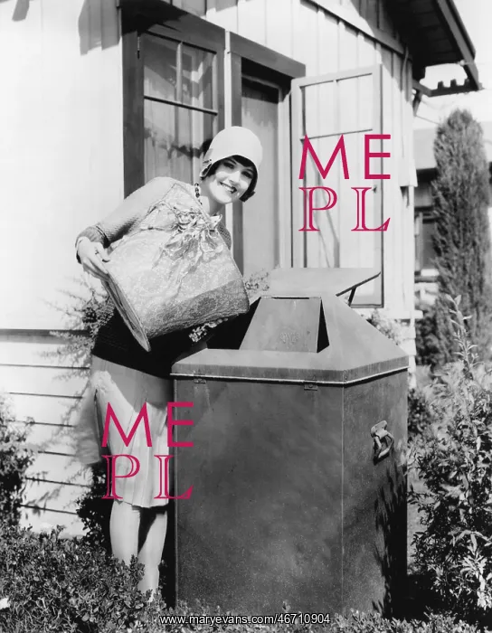 : Young woman putting garbage into a garbage can : Young woman putting garbage into a garbage can