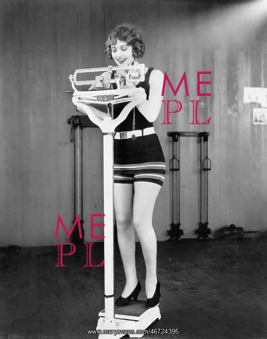 : Young woman on a scale taking her weight : Young woman on a scale taking her weight