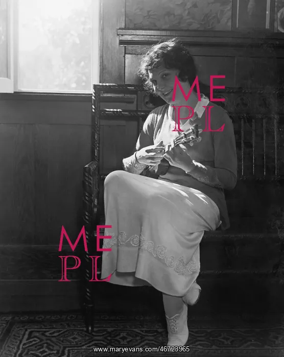 : Young woman sitting on a bench playing the mandolin : Young woman sitting on a bench playing the mandolin