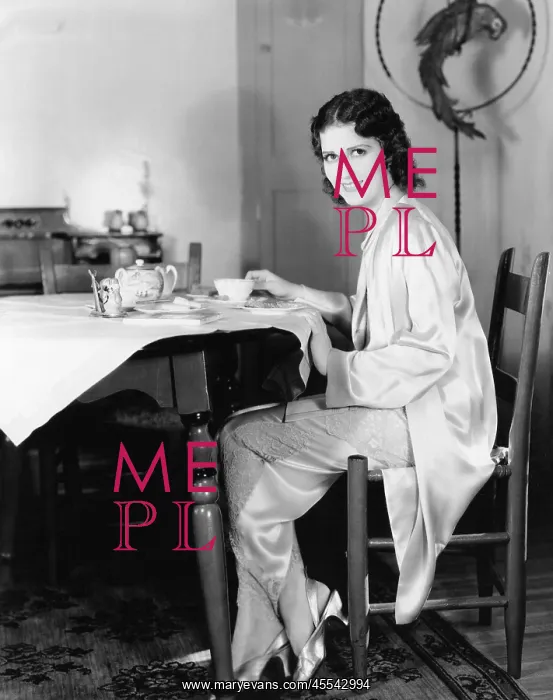 : Young woman sitting at a table having breakfast tea : Young woman sitting at a table having breakfast tea