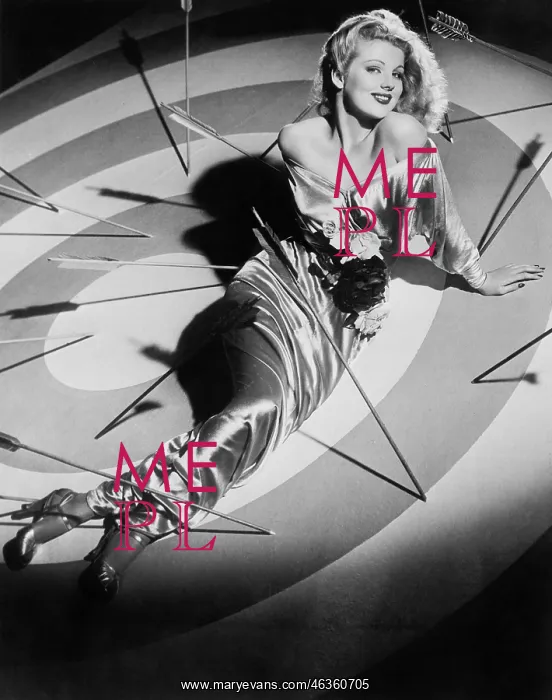 : Young woman sitting on a target with arrows around her : Young woman sitting on a target with arrows around her