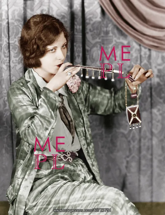: Young woman smoking a cigarette with a cigarette extension : Young woman smoking a cigarette with a cigarette extension