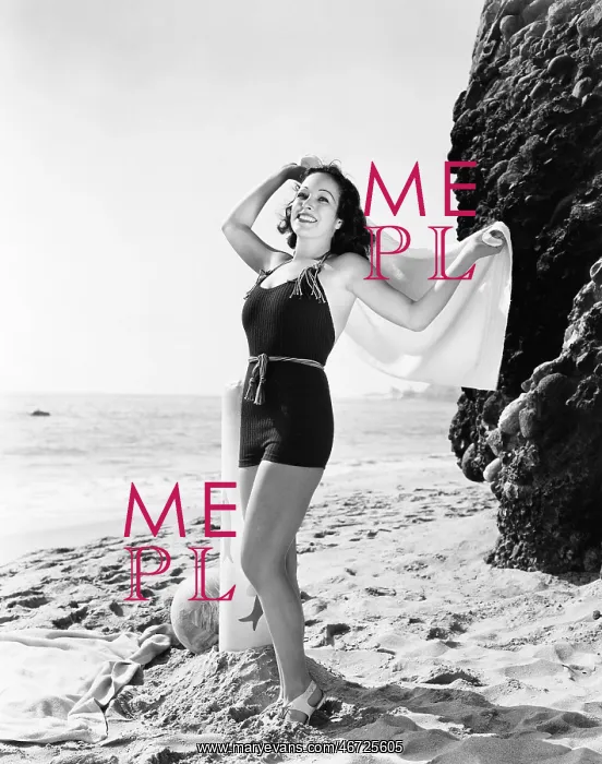 : Young woman standing on the beach and smiling : Young woman standing on the beach and smiling