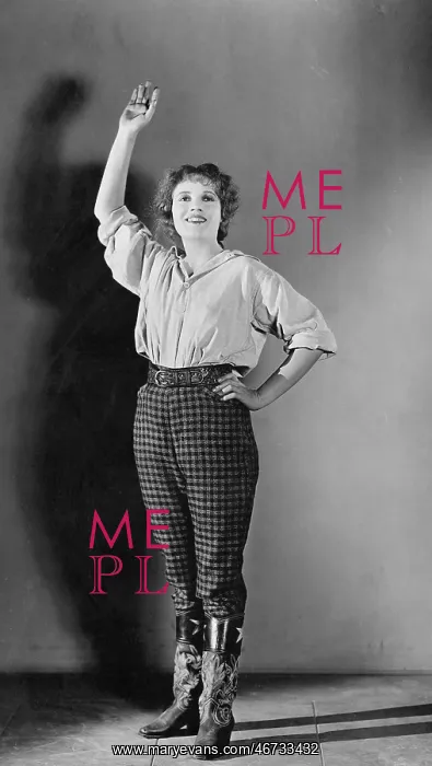  : Young woman standing with her hand raised and smiling