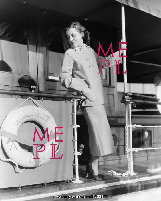 : Young woman standing at the railing of a boat : Young woman standing at the railing of a boat