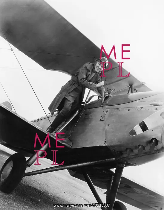 : Young woman standing on the wing of an airplane : Young woman standing on the wing of an airplane