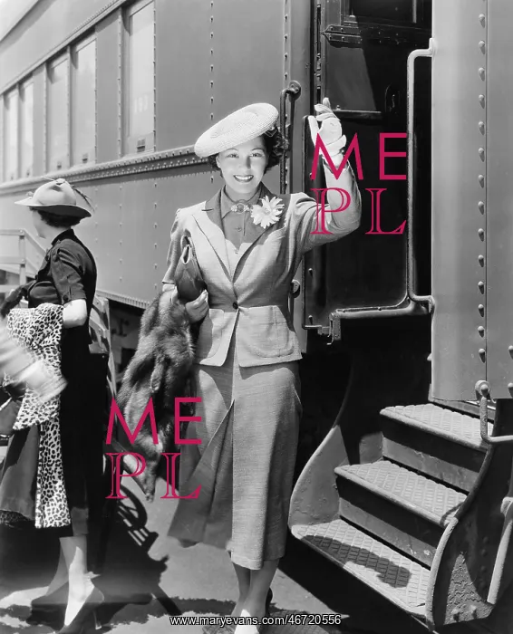 : Young woman next to train waving : Young woman next to train waving