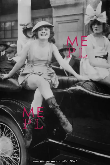: Three young women in bathing suits perched on a : Three young women in bathing suits perched on a