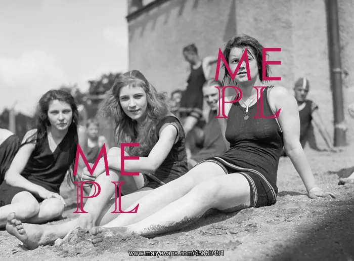 : Three young women in bathing suits on sandy beach : Three young women in bathing suits on sandy beach