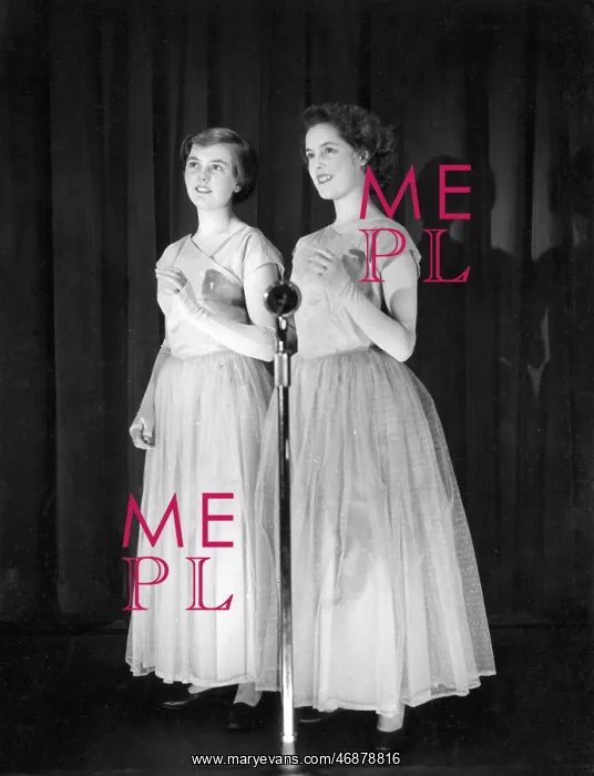 : Two young women performing on stage : Two young women performing on stage