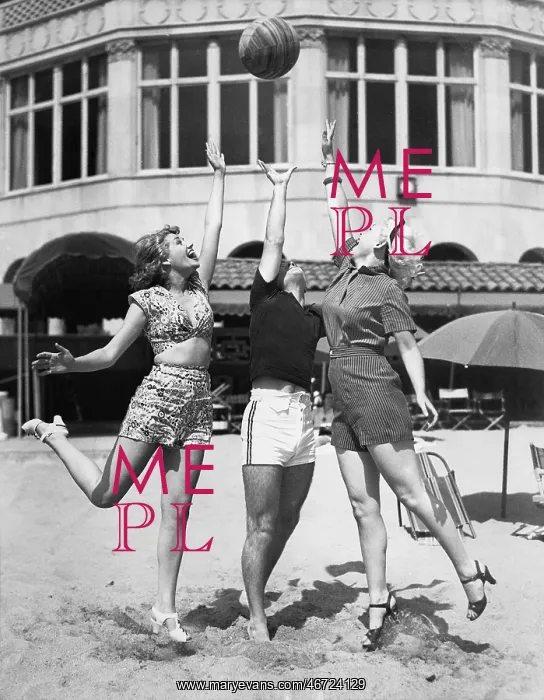 : Three young women playing with a ball on the beach : Three young women playing with a ball on the beach