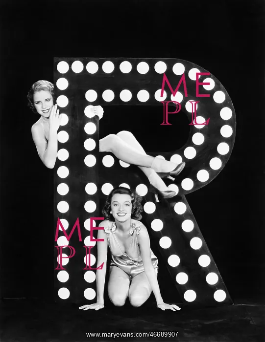 : Two young women posing with the letter R : Two young women posing with the letter R