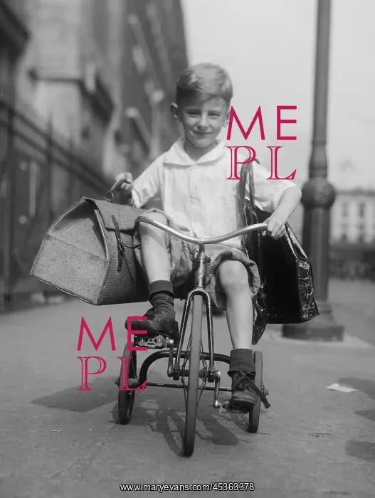 : Youngster rides his tricycle on the sidewalks of : Youngster rides his tricycle on the sidewalks of