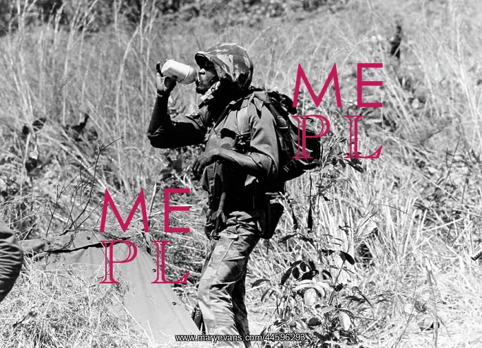 : Zaire soldier takes a drink at the front lines : Zaire soldier takes a drink at the front lines