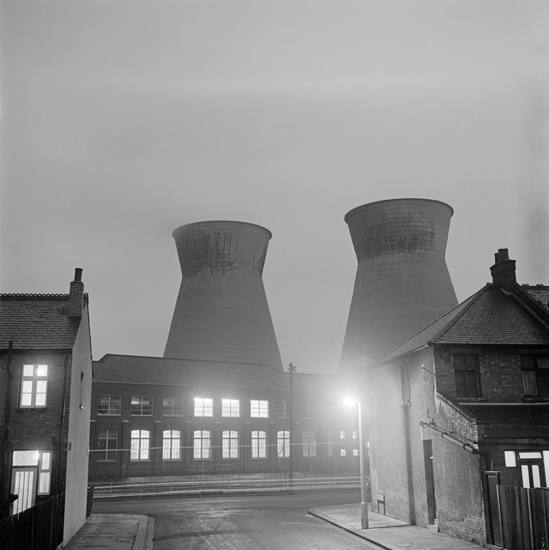General view of the cooling towers of the power station at Church End, Harlesden at night from the west from Crouch Road, London Date: 1965