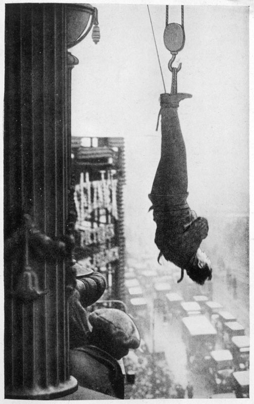 Harry Houdini (1874-1926), American stunt performer. Suspended from the cornice of a New York skyscraper, he must somehow free himself of his chains and make his way to safety ... will he do it ? Is this one trick too many?
circa 1920s