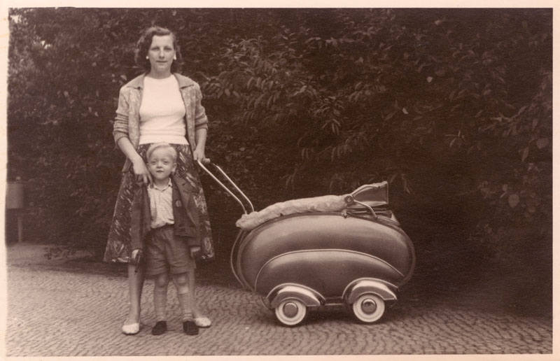 Mother and her son with a streamlined pram - Classic 1950s German design. Date: circa early 1950s