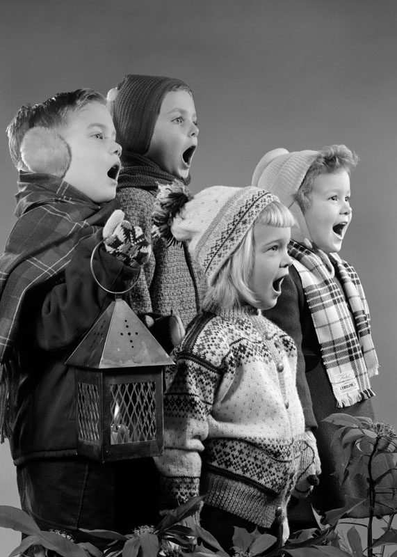 1950s FOUR CHILDREN TWO BOYS TWO GIRLS SINGING CHRISTMAS CAROL TOGETHER HOLDING CANDLE LANTERN