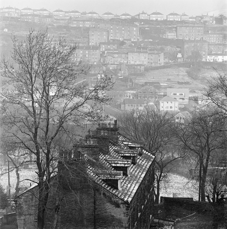 General view of the Hebble Valley, in the Denfield and Bracewell areas of Ovenden, Halifax, West Yorkshire, looking from Brackenbeds, Pellon, Halifax across towards Wheatley, showing a terrace of old stone houses in the foreground and a modern council estate on the opposite side of the valley.
1962 - 1976