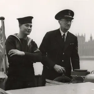 A. P. Herbert steering a riverboat on the River Thames