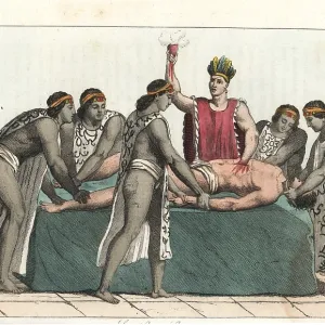 An Aztec priest removes a man's heart in a human sacrifice