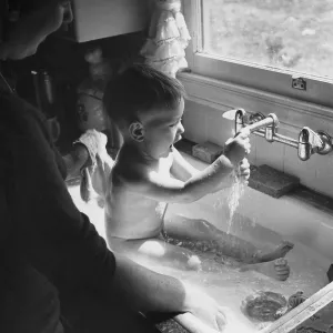 BABY BATHING IN THE SINK