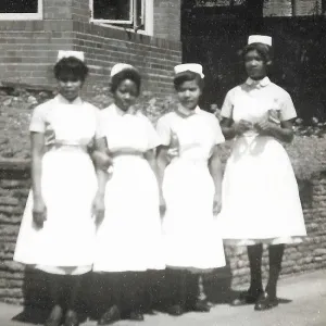 Four black nurses stand by the hospital wall in Nottingham Four black nurses stand by the hospital wall in Nottingham
