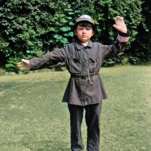 Boy in policeman's uniform in a garden Boy in policeman's uniform in a garden