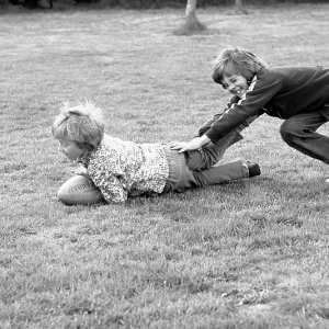 Two boys playing on the grass