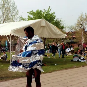 British Caribbean runner standing with wind swept foil wrap British Caribbean runner standing with wind swept foil wrap