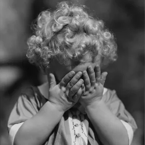 Child with hands to face Child with hands to face