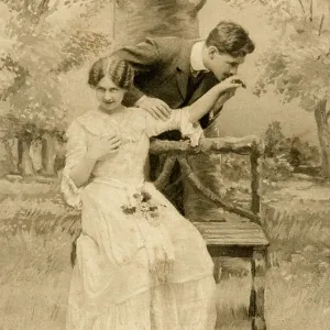 Couple canoodling on a bench Couple canoodling on a bench