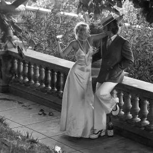 COUPLE DRINK ON VERANDA