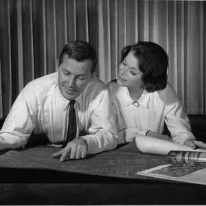 Couple indoors looking at blueprints Couple indoors looking at blueprints