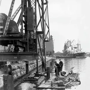 Dockside scene with men on a raft, London Dockside scene with men on a raft, London