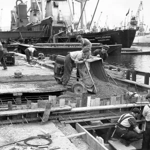 Dockside scene with vessels and men at work, London Dockside scene with vessels and men at work, London