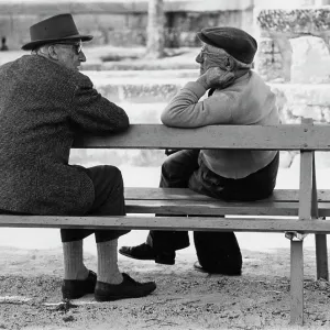 Two elderly men chatting on a bench Two elderly men chatting on a bench