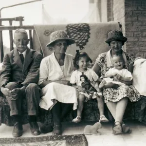 Family group on a sofa on a verandah Family group on a sofa on a verandah