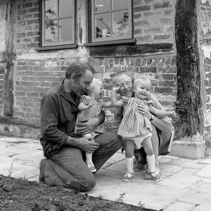 Family of four outside their house Family of four outside their house