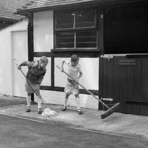 Two girls mopping and sweeping up Two girls mopping and sweeping up