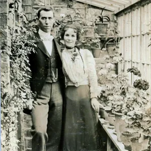 A very handsome couple in their greenhouse
