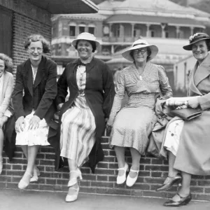 Holiday group sitting on a wall in Margate, Kent Holiday group sitting on a wall in Margate, Kent